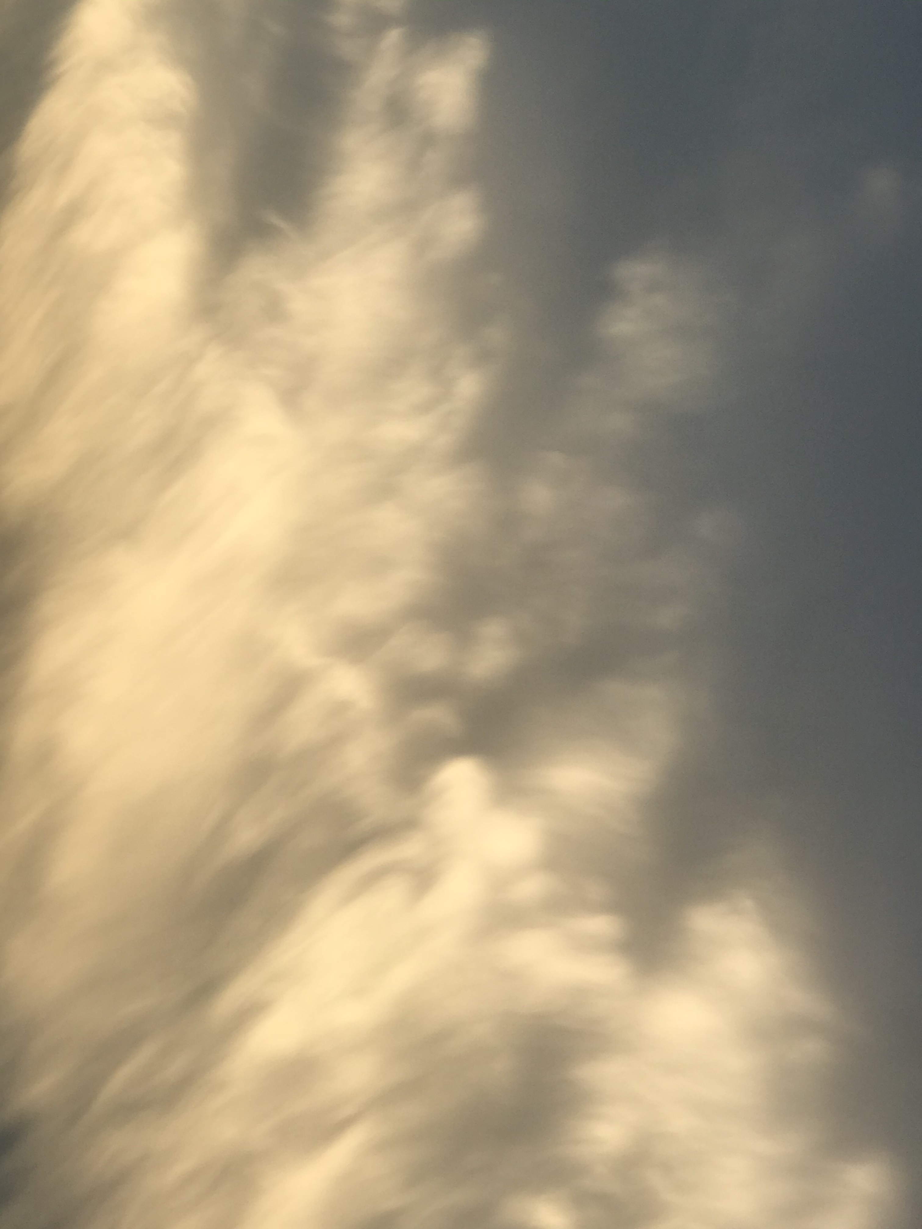 A photograph of clouds that appear to be falling.